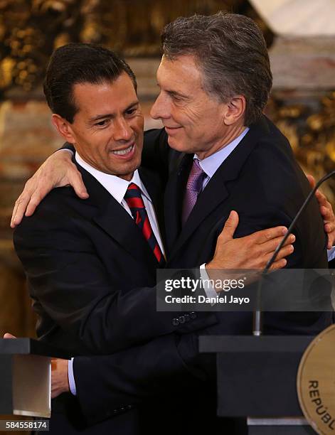 Enrique Pena Nieto, president of Mexico and Mauricio Macri, president of Argentina embrace each other during a official visit to Argentina at Casa...