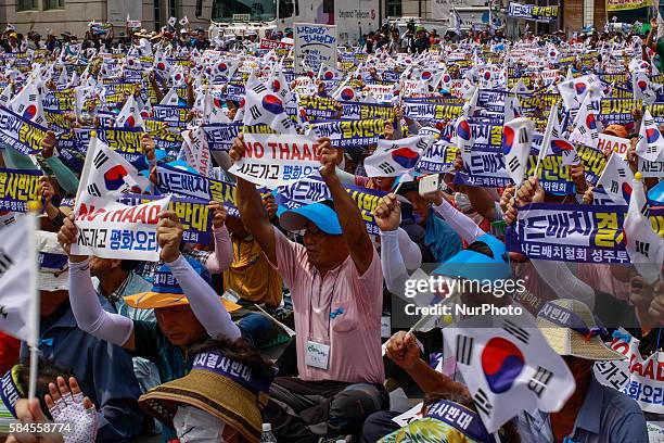 South Korean town residents shouts slogans protesting a plan to deploy an advanced U.S. Missile defense system called Terminal High-Altitude Area...