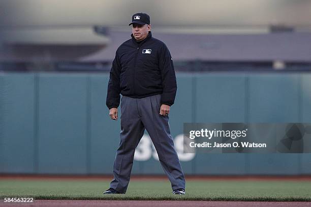 Umpire Andy Fletcher stands on the field during the first inning between the San Francisco Giants and the Cincinnati Reds at AT&T Park on July 26,...