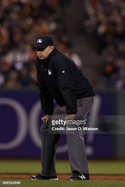 Umpire Andy Fletcher stands on the field during the seventh inning between the San Francisco Giants and the Cincinnati Reds at AT&T Park on July 26,...