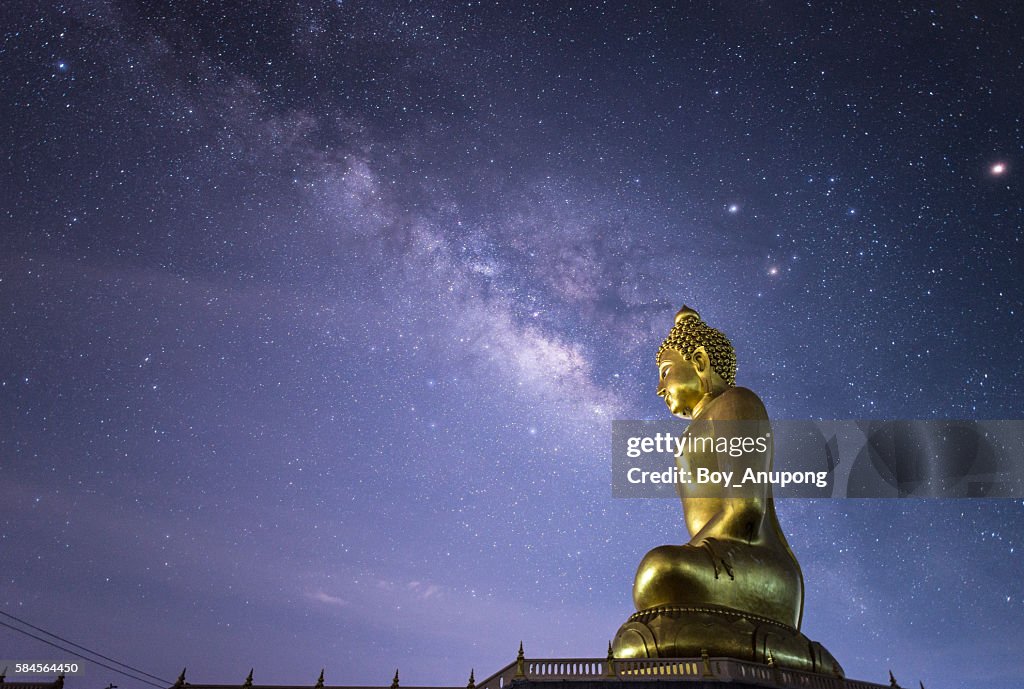 The Milky way over the Big Buddha image in the countryside of Thailand.