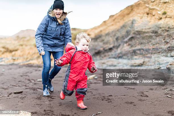 family play on the beach in winter - s0ulsurfing stock pictures, royalty-free photos & images
