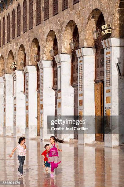 children running in umayyad mosque, damascus, syria - umayyad mosque stock pictures, royalty-free photos & images