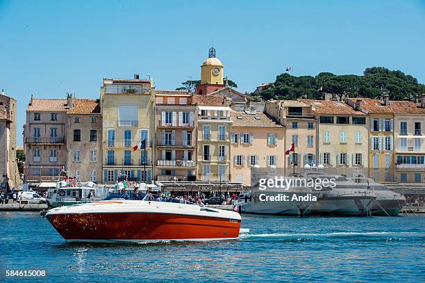 Luxury yachts in the marina of Saint-Tropez, French Riviera Launch and building facades in the Old Town of Saint Tropez
