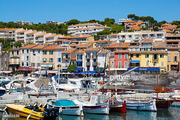 Cassis , July 2014: boats in the harbor, facades of colorful houses