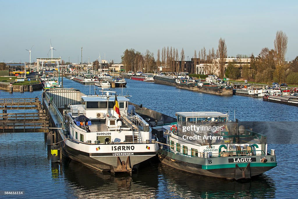 Inland navigation vessels / cargo canal boats on the Ringvaart waiting at the Evergem lock to enter the Ghent port, Belgium