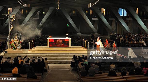 Church service at the Basilica of Saint Pius X / Underground Basilica at the Sanctuary of Our Lady of Lourdes, Pyrenees, France.