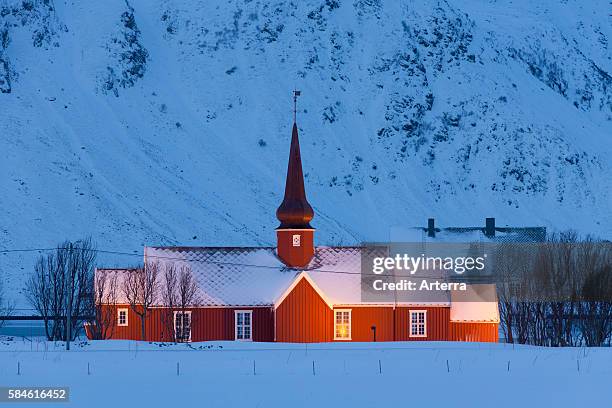 The Flakstad church at night in the snow in winter, Fylke Nordland, Lofoten, Norway.