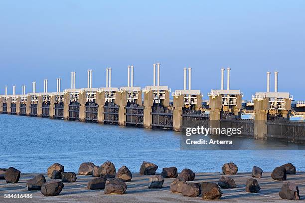 Storm flood barrier / Oosterscheldekering / Eastern Scheldt storm surge barrier at Neeltje Jans, part of the Delta Works that regulates the enormous...