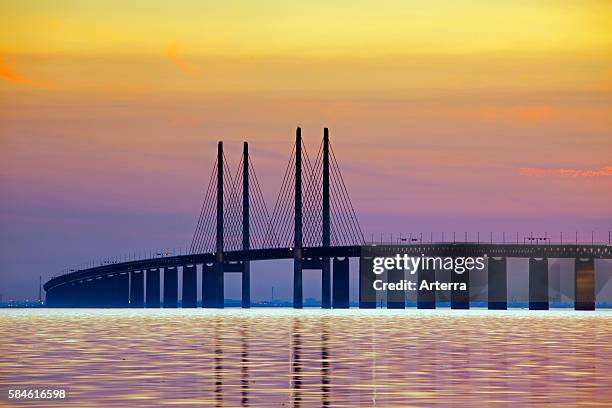 Oeresund / Ì÷resund Bridge, double-track railway and dual carriageway bridge-tunnel between Denmark and Sweden at sunset, Scandinavia.