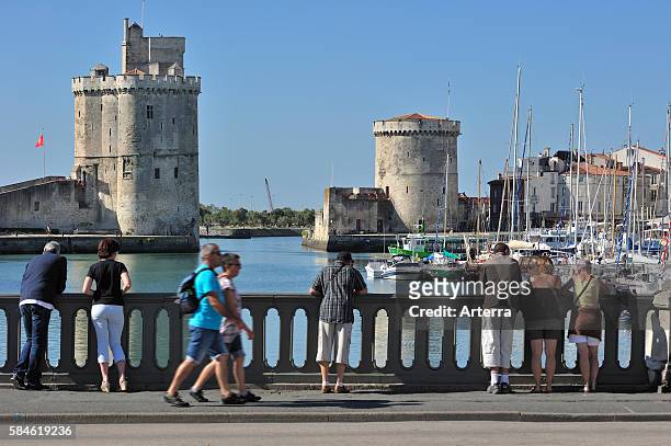 The medieval towers tour de la Chaine and tour Saint-Nicolas in the old harbour / Vieux-Port at La Rochelle, Charente-Maritime, France.
