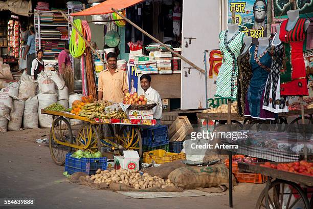 Vendors selling fruit on cart at market in Mathura, Uttar Pradesh, India.