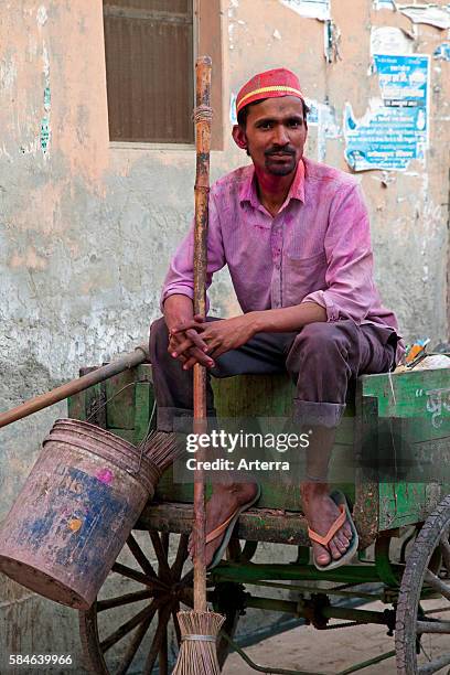 Indian garbage man on wooden cart in Vrindavan, Uttar Pradesh, India.