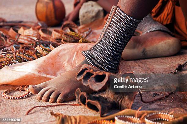 Close up of woman's feet decorated with anklets and jewellery of the Himba tribe, Namibia, South Africa.