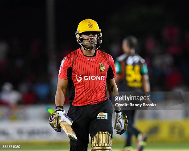 Florida , United States - 29 July 2016; Umar Akmal of Trinbago Knight Riders walks off the field after being dismissed for 5 runs during Match 26 of...
