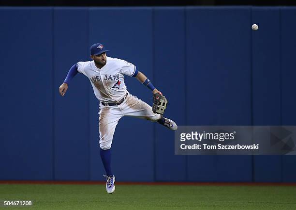 Kevin Pillar of the Toronto Blue Jays blocks a single by Jonathan Schoop of the Baltimore Orioles as the ball skips away from him in the fourth...
