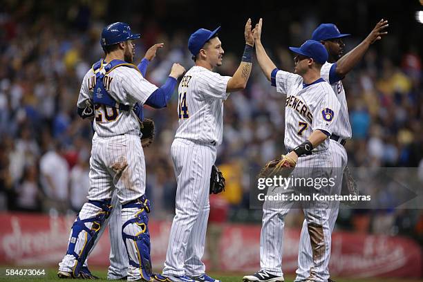 Jonathan Lucroy of the Milwaukee Brewers, Hernan Perez, Jake Elmore and Chris Carter celebrate their 3-1 win over the Pittsburgh Pirates during the...