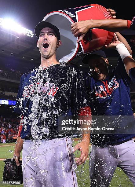Rick Porcello of the Boston Red Sox gets a bucket of ice water on his head after throwing a complete game and defeating the Los Angeles Angels 6-2 at...