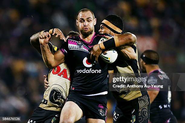 Simon Mannering of the Warriors on the charge against Sitaleki Akauola of the Panthers during the round 21 NRL match between the New Zealand Warriors...