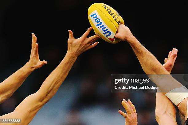 The ball compacts against the fist of Nathan Brown of the Magpies during the round 19 AFL match between the Collingwood Magpies and the West Coast...