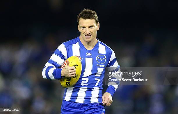 Brent Harvey of the Kangaroos in his long-sleeved jumper warms up before the round 19 AFL match between the North Melbourne Kangaroos and the St...