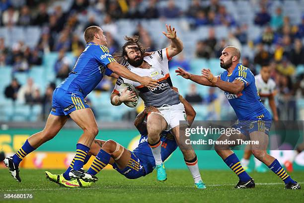 Aaron Woods of the Tigers is tackled by the Eels defence during the round 21 NRL match between the Parramatta Eels and the Wests Tigers at ANZ...