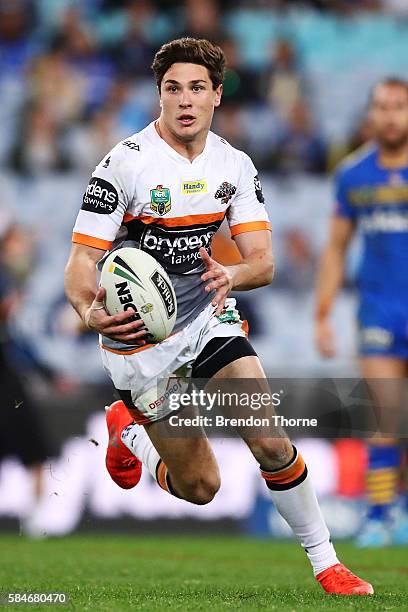 Mitchell Moses of the Tigers runs the ball during the round 21 NRL match between the Parramatta Eels and the Wests Tigers at ANZ Stadium on July 30,...