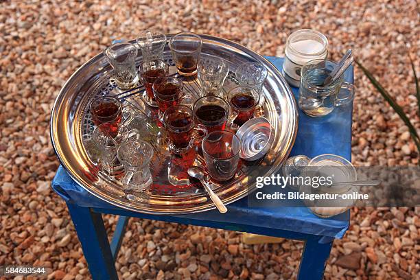 Elephantine Island, Silver tray with tea glasses stands on a blue table, teatime in Egypt.