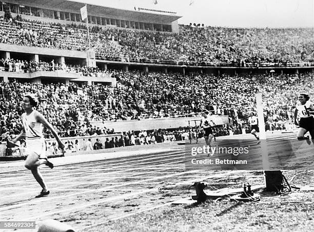 Helen Stephens, America's star women sprinter, crosses the finish line first as anchor of the 100-meter relay team, at the Olympic Games in Berlin....