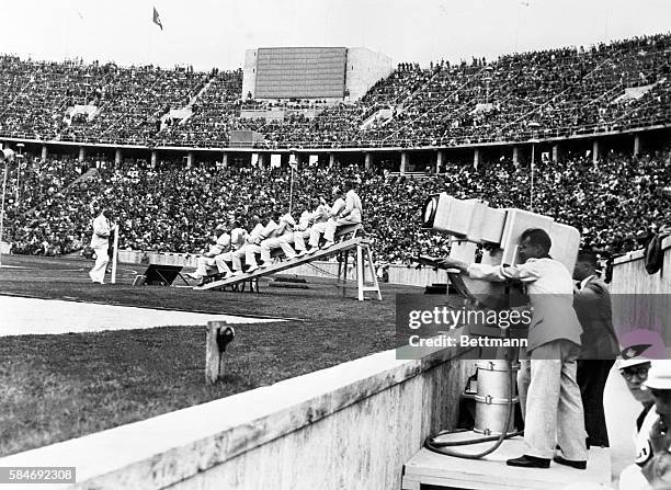 No, there isn't a see-saw event in the Olympic Games, those men straddling the inclined platform, are judges at the finish line of the 100-meter...