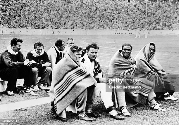Here are some of the contestants in the 100-meters dash at the Olympic Games in Berlin, swathed in blankets after running their race. Left to right,...