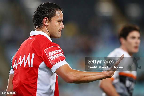 Referee, Henry Perenara gestures to James Tedesco of the Tigers after colliding with him during the round 21 NRL match between the Parramatta Eels...