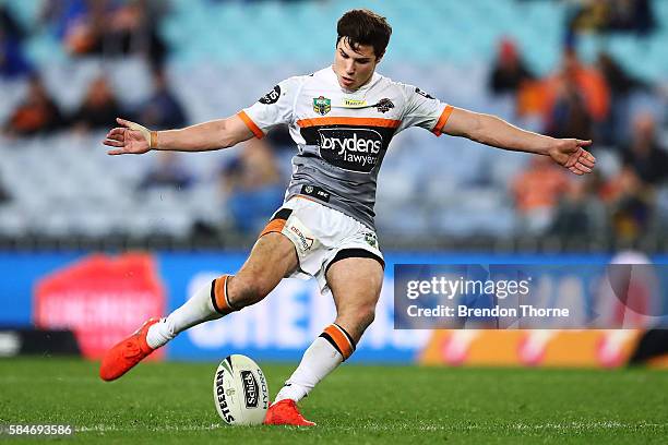 Mitchell Moses of the Tigers kicks a field goal during the round 21 NRL match between the Parramatta Eels and the Wests Tigers at ANZ Stadium on July...