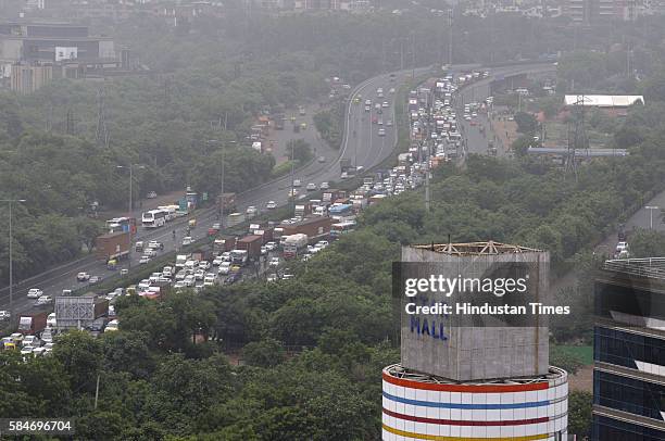 Heavy traffic jam at Signature Tower Chowk, NH8 due to heavy rainfall, as more than 150 vehicles broke-down on the highway due to water entering into...