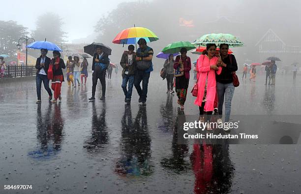 People enjoy during heavy rain at Ridge, on July 29, 2016 in Shimla, India. Shimla district has received 76mm rainfall so far. Palampur, Dharamsala...