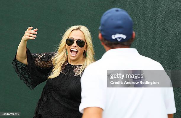 Amy Mickelson greets husband Phil Mickelson of the United States on the 18th hole after his third round of the 2016 PGA Championship at Baltusrol...