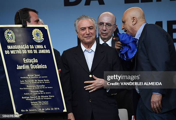 Brazil's acting president Michel Temer and Rio de Janeiro's state Governor Luiz Fernando Pezao attend the inauguration of the Line 4 in Rio de...