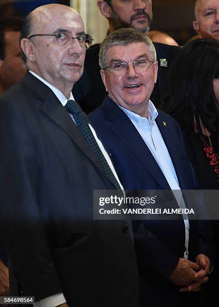 Brazil's Finance Ministes Henrique Meirelles and the president of the International Olympic Committee Thomas Bach attend the inauguration of the...