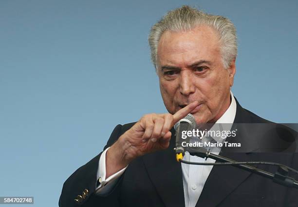 Brazil's interim President Michel Temer pauses at an event inaugurating the new Metro Line 4 subway train which links the Ipanema and Barra da Tijuca...