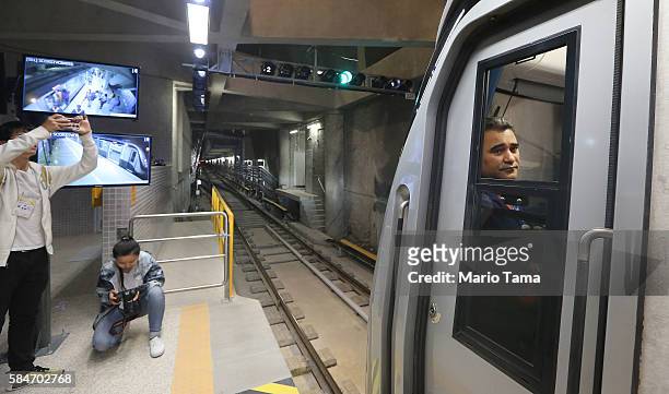 Worker looks out from a train on the new Metro Line 4 subway train which links the Ipanema and Barra da Tijuca neighborhoods following an event...
