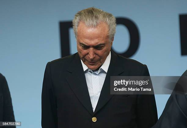 Brazil's interim President Michel Temer pauses at an event inaugurating the new Metro Line 4 subway train which links the Ipanema and Barra da Tijuca...