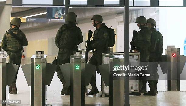 Brazilian soldiers patrol a station on the new Metro Line 4 subway train which links the Ipanema and Barra da Tijuca neighborhoods following an event...