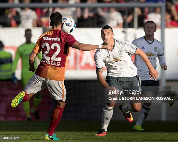 Galatasaray's Hakan Balta controls the ball in front of Manchester United's Zlatan Ibrahimovic during the Galatasaray v Manchester United pre-season...