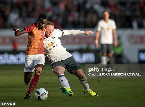 United's Wayne Rooney vies with Galatasaray's Hakan Balta during the Galatasaray v Manchester United pre-season friendly football match on Ullevi...