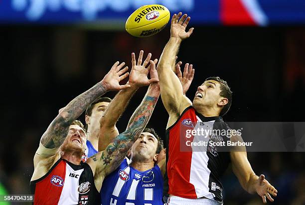 Michael Firrito of the Kangaroos, Tim Membrey of the Saints and Darren Minchington of the Saints compete for the ball during the round 19 AFL match...