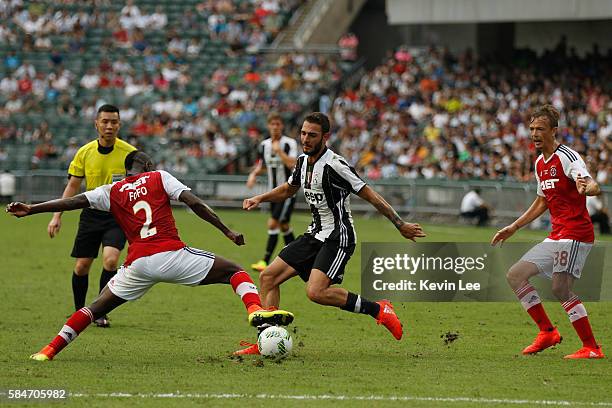 Medhi Benatia of Juventus FC fight for the ball with Agbo Wisdom Fofo of South China during the match between Juventus FC and South China of Hong...
