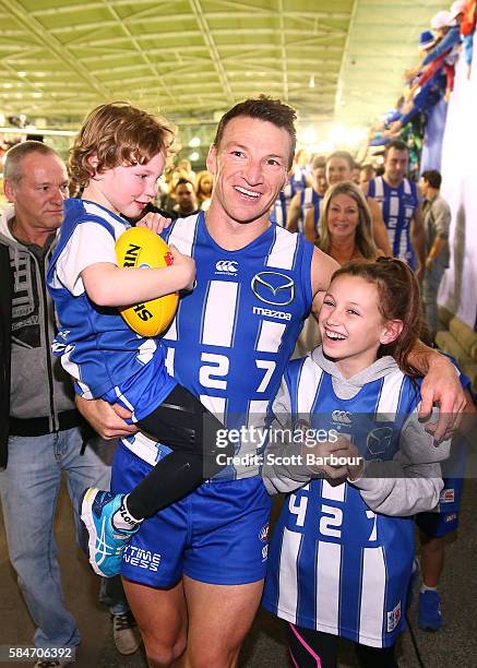 Brent Harvey of the Kangaroos is congratulated his children Lacie Harvey, Cooper Harvey and Hudson Harvey as he leaves the field after the round 19...