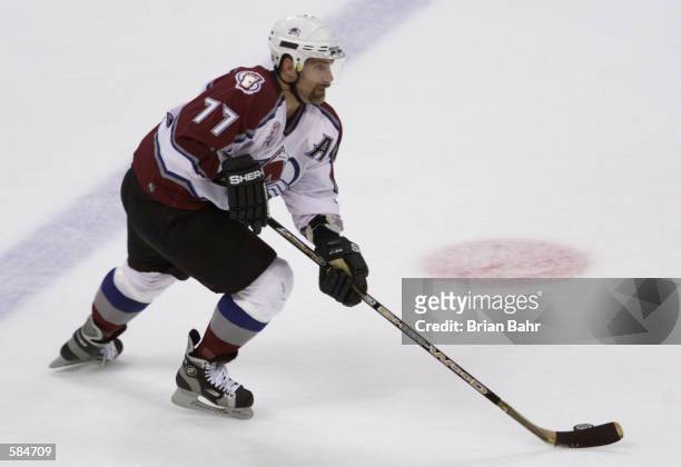 Ray Bourque of the Colorado Avalanche brings the puck down ice against the New Jersey Devils during game seven of the Stanley Cup finals at the Pepsi...