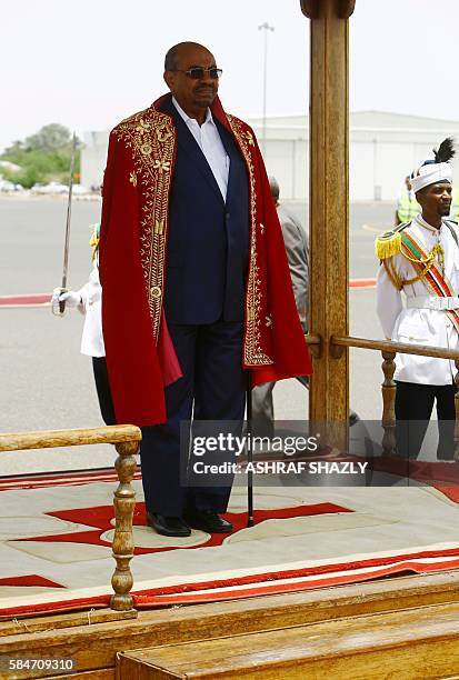 Sudanese President Omar al-Bashir reviews troops during a welcome ceremony upon his arrival at the airport on July 30, 2016 in the capital Khartoum....