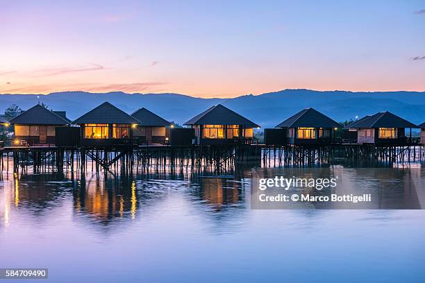 inle lake, nyaungshwe township, taunggyi district, myanmar (burma). shwe inn tha floating resort's bungalows. - strohgedeckte strandhütte stock-fotos und bilder